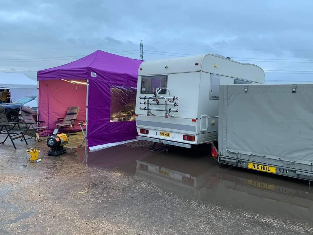 A caravan beside a purple pop up track day tent