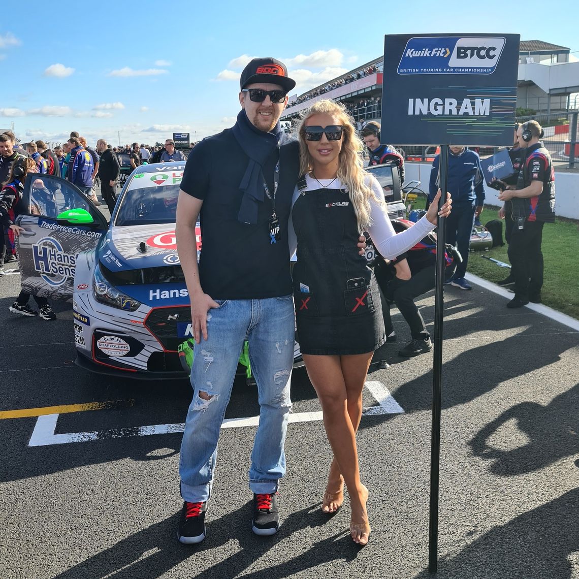 A man poses with a grid girl at Donington park