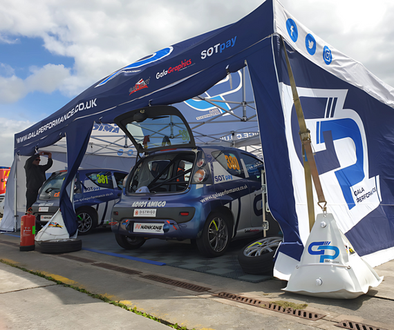 mazda mx5 race car under green pop up gazebo