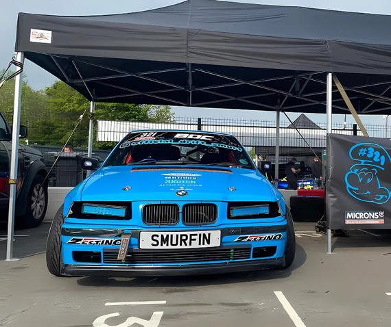 smurfin blue bmw drift car under tent